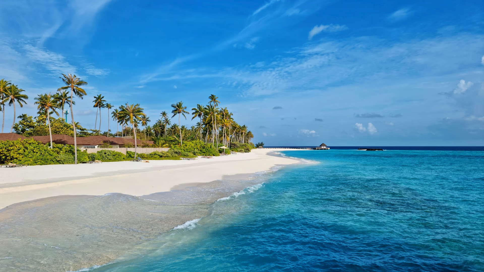 Experience the serene beauty of Maldives with turquoise waters and white sandy beach under a clear blue sky - Image by Geek Wandering from Pexels