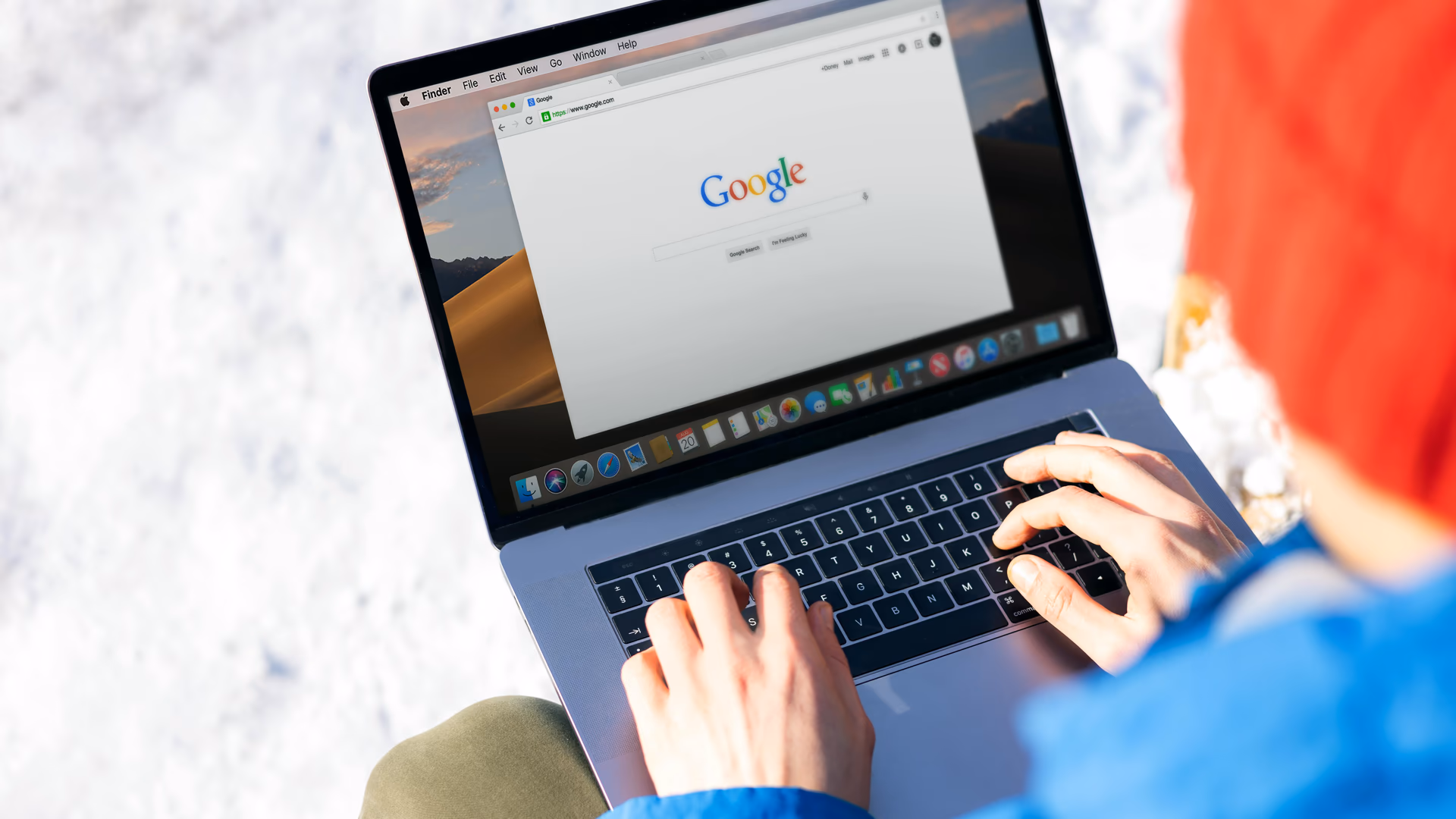 Individual typing on a laptop outdoors with snow, accessing the internet - Image by Firmbee from Pexels