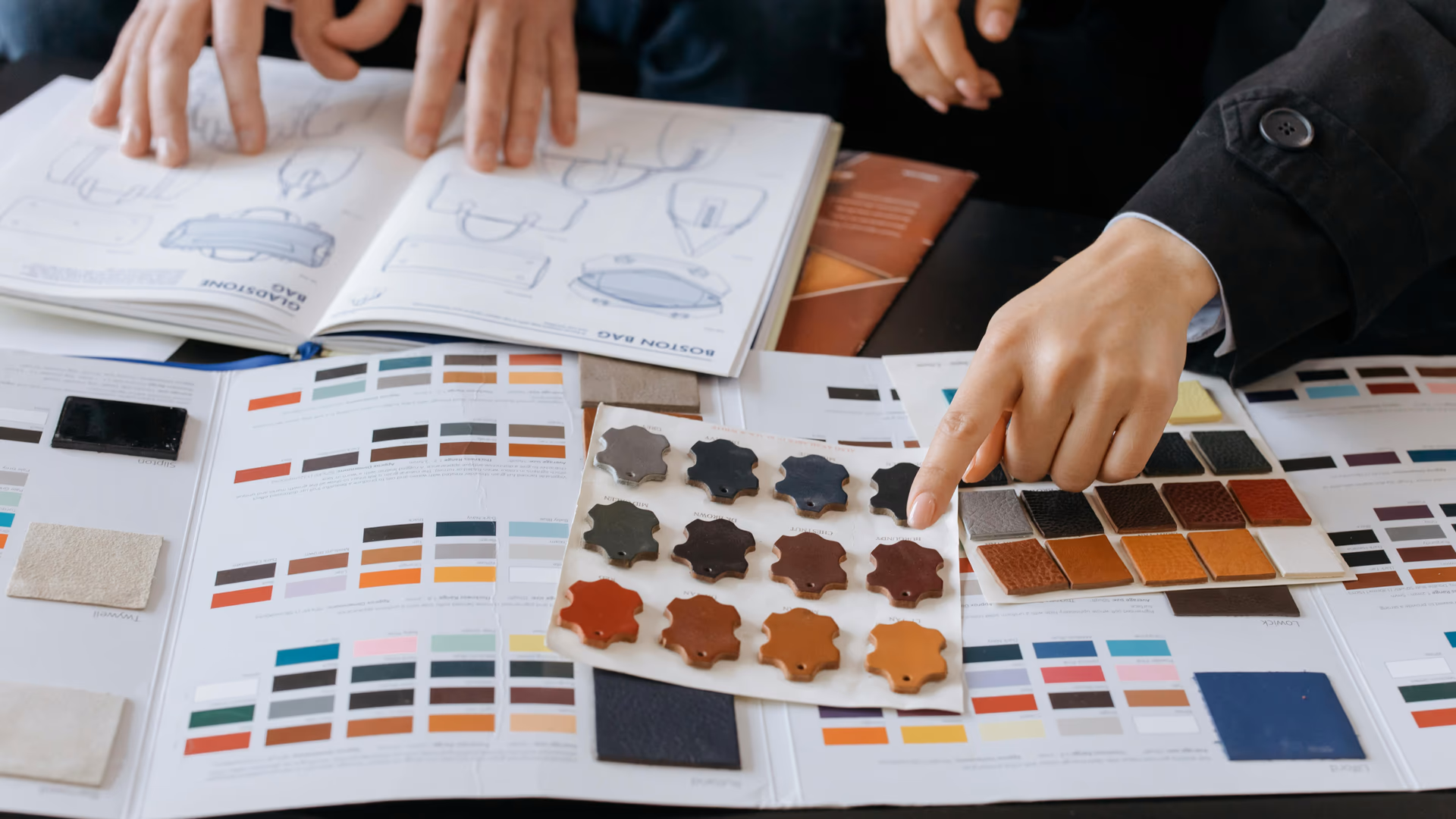 Designers reviewing color swatches and sketches for project planning - Image by cottonbro studio from Pexels