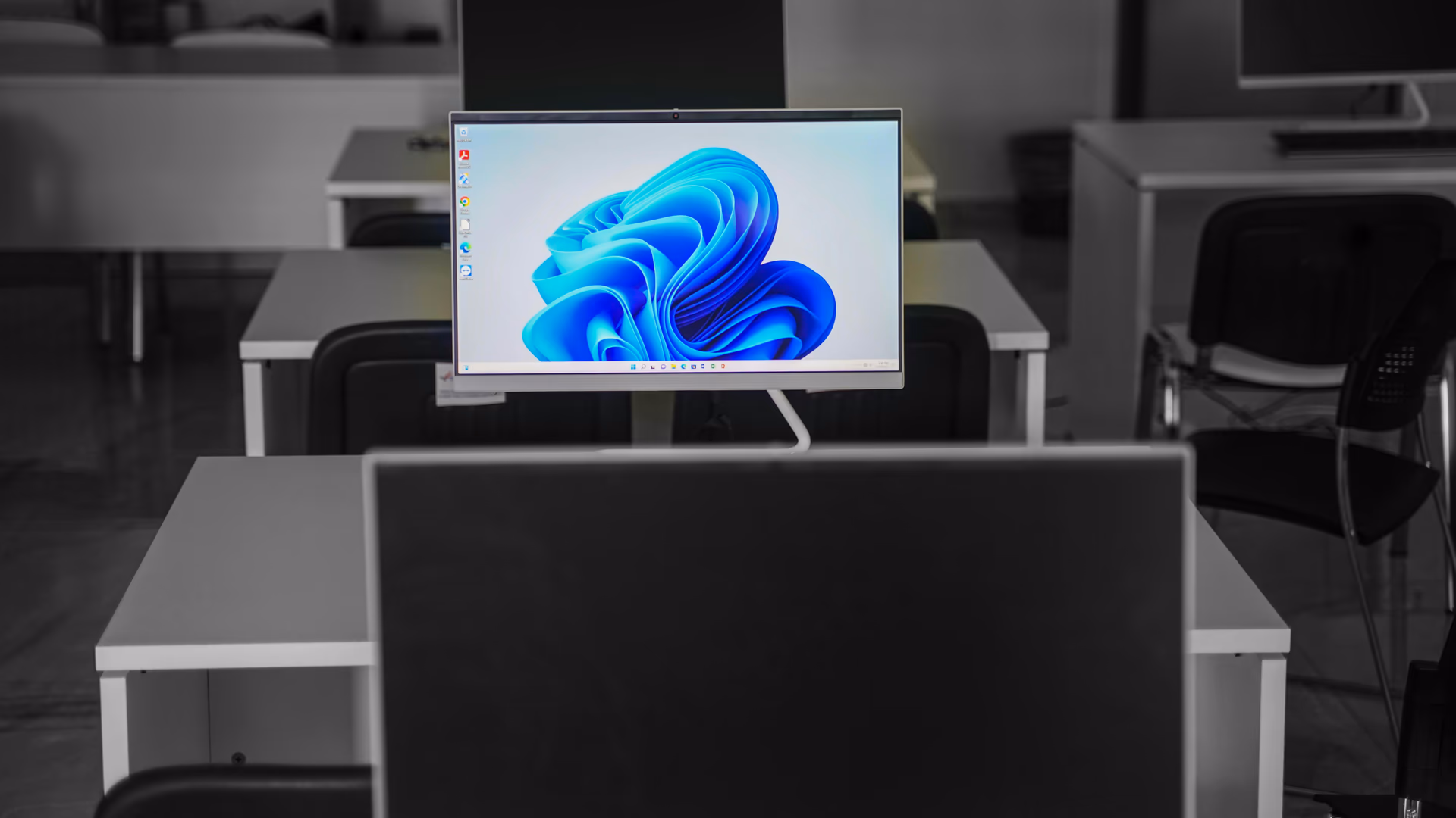 A contemporary office setup featuring computers on desks with modern flat screens - Image by Vladimir Srajber from Pexels