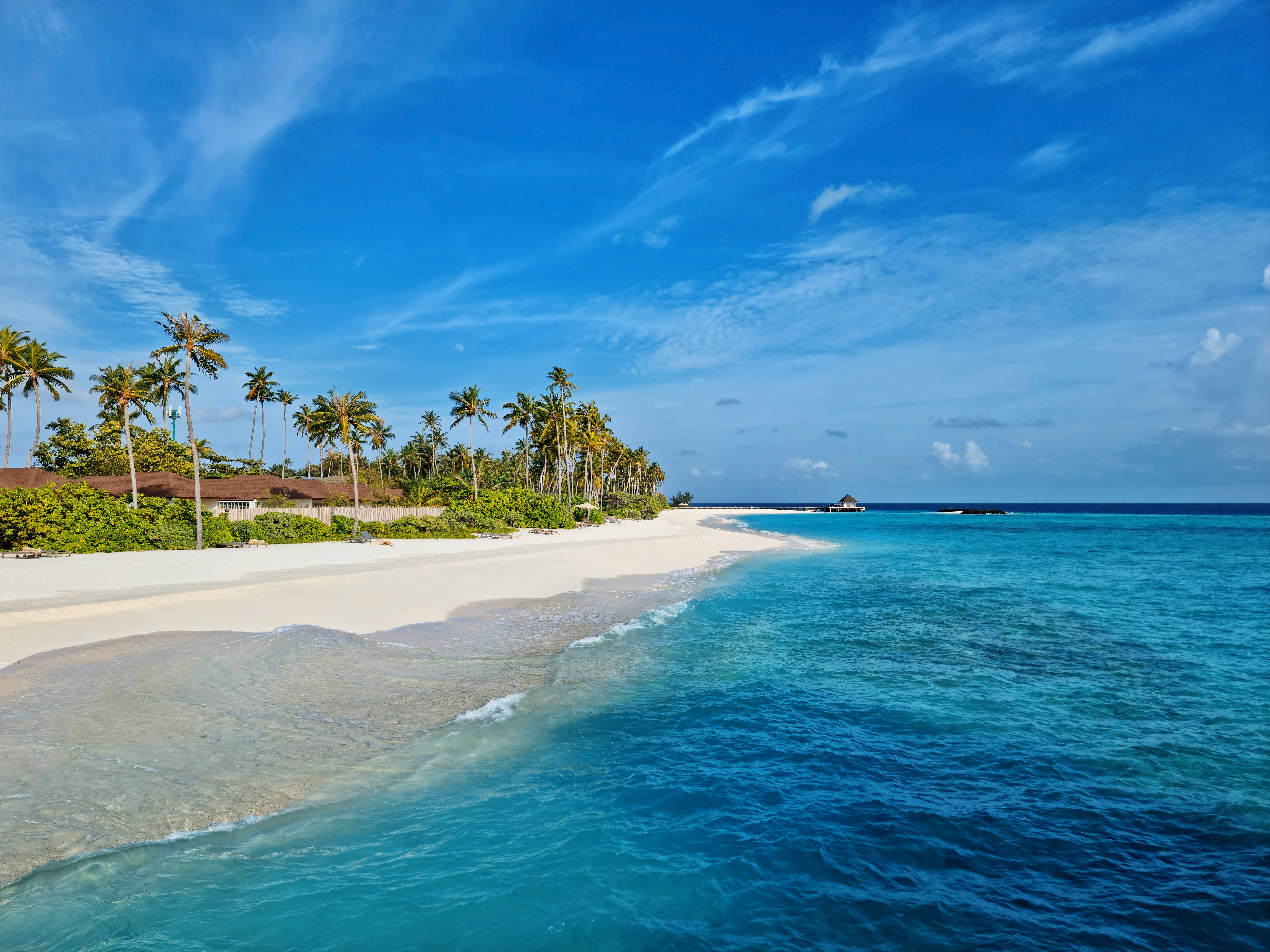 Experience the serene beauty of Maldives with turquoise waters and white sandy beach under a clear blue sky - Image by Geek Wandering from Pexels